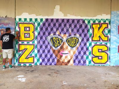 Violet and Yellow and Cyan Characters by bzks. This Graffiti is located in Thessaloniki, Greece and was created in 2022. This Graffiti can be described as Characters, Stylewriting and Futuristic.