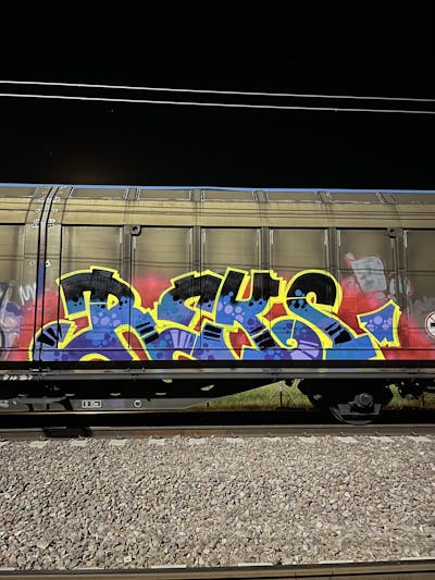 Yellow and Red and Light Blue Stylewriting by REKS. This Graffiti is located in Italy and was created in 2023. This Graffiti can be described as Stylewriting, Trains and Freights.