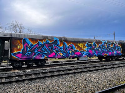 Light Blue and Colorful Stylewriting by omseg and Kosem. This Graffiti is located in Freiburg, Germany and was created in 2023. This Graffiti can be described as Stylewriting, Trains, Wholecars and Freights.