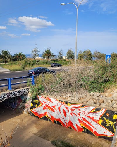 Red and Chrome Stylewriting by Riots. This Graffiti is located in Palma de Mallorca, Spain and was created in 2023. This Graffiti can be described as Stylewriting and Street Bombing.