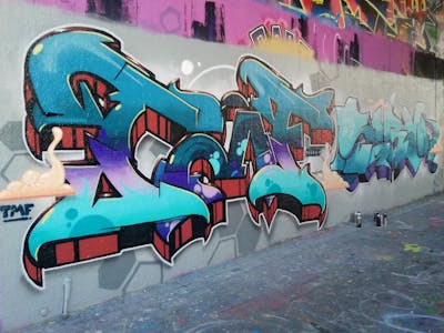 Cyan and Violet and Red Wall of Fame by Chr15, Sirom and TMF. This Graffiti is located in Leipzig, Germany and was created in 2023. This Graffiti can be described as Wall of Fame and Stylewriting.