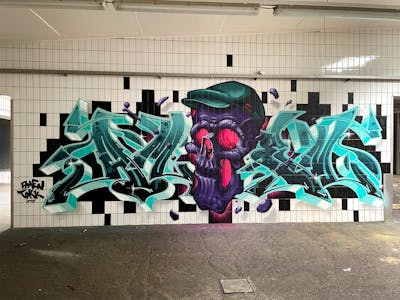 Violet and Cyan Stylewriting by Tokk and Amen. This Graffiti is located in Bremen, Germany and was created in 2022. This Graffiti can be described as Stylewriting, Characters and Abandoned.