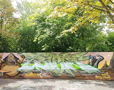 Brown and Beige Stylewriting by Riots and Kasimir. This Graffiti is located in Dresden, Germany and was created in 2022. This Graffiti can be described as Stylewriting, Characters and Wall of Fame.