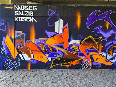 Violet and Orange Stylewriting by Moseg and omseg. This Graffiti is located in Freiburg, Germany and was created in 2022. This Graffiti can be described as Stylewriting and Wall of Fame.