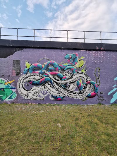 Colorful and Cyan and White Characters by REVES ONE and This One. This Graffiti is located in United Kingdom and was created in 2023. This Graffiti can be described as Characters, Murals and Streetart.