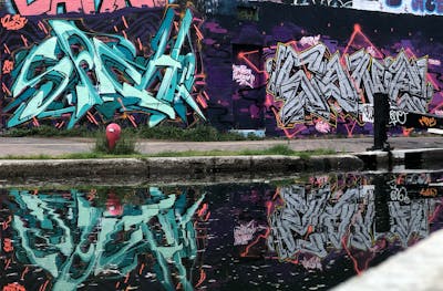 Cyan and Chrome and Violet Stylewriting by Chips and Soner. This Graffiti is located in London, United Kingdom and was created in 2021. This Graffiti can be described as Stylewriting, Atmosphere and Wall of Fame.