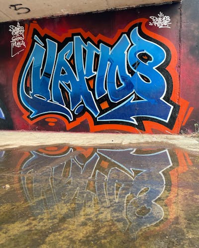 Blue and Red Stylewriting by Vamos. This Graffiti is located in Valencia, Spain and was created in 2022. This Graffiti can be described as Stylewriting and Wall of Fame.
