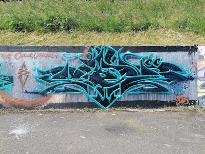 Black and Cyan Stylewriting by Dest Jones and TCC. This Graffiti is located in Basel, Switzerland and was created in 2022.