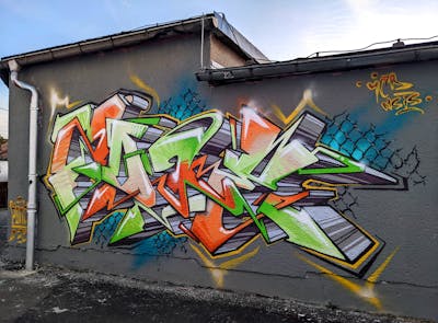 Light Green and Orange and Grey Stylewriting by Zone 56. This Graffiti is located in Glauchau, Germany and was created in 2023.