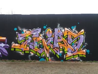 Violet and Light Green and Orange Stylewriting by Trias. This Graffiti is located in Germany and was created in 2022.