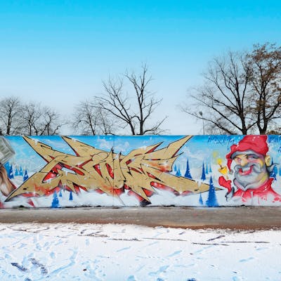 Gold and Light Blue Stylewriting by Riots and Able2. This Graffiti is located in Mühlberg, Germany and was created in 2023. This Graffiti can be described as Stylewriting, Characters and Wall of Fame.