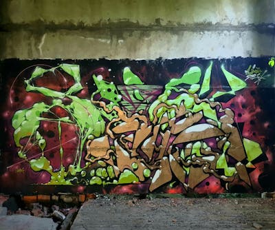 Gold and Light Green Stylewriting by SIDOK. This Graffiti is located in Mukachevo, Ukraine and was created in 2021. This Graffiti can be described as Stylewriting and Abandoned.