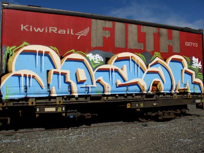 Light Blue and Beige Stylewriting by Kezam. This Graffiti is located in Auckland, New Zealand and was created in 2024. This Graffiti can be described as Stylewriting, Trains, Freights and 3D.