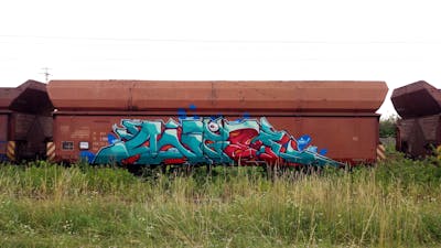 Cyan and Red Stylewriting by DCK, Angel and ALL CAPS COLLECTIVE. This Graffiti is located in Hungary and was created in 2019. This Graffiti can be described as Stylewriting, Trains and Freights.