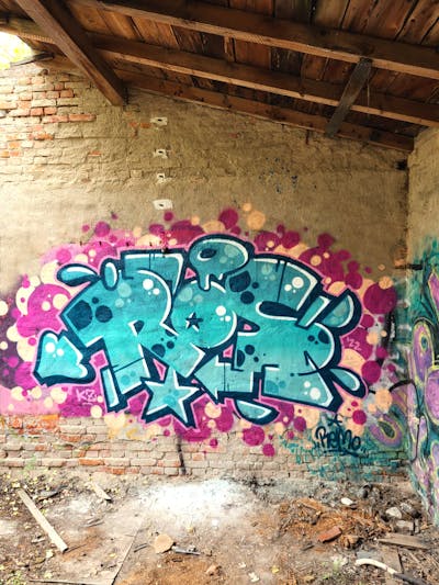 Cyan and Violet Stylewriting by Remo and Ros. This Graffiti is located in Germany and was created in 2022. This Graffiti can be described as Stylewriting and Abandoned.