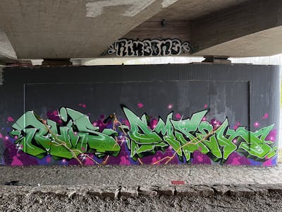 Green and Light Green and Colorful Stylewriting by omseg and Ruis. This Graffiti is located in Freiburg, Germany and was created in 2023. This Graffiti can be described as Stylewriting and Wall of Fame.