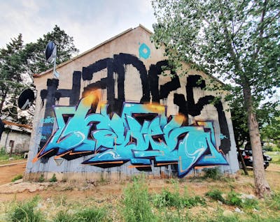 Cyan and Orange and Black Stylewriting by Hades. This Graffiti is located in Sarajevo, Bosnia and Herzegovina and was created in 2021. This Graffiti can be described as Stylewriting, Roll Up and Abandoned.
