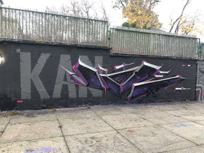 Grey and Violet Stylewriting by TMF and Kan. This Graffiti is located in Weimar, Germany and was created in 2022. This Graffiti can be described as Stylewriting, 3D and Wall of Fame.
