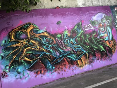 Colorful Stylewriting by Fresk. This Graffiti is located in Poznan, Poland and was created in 2022. This Graffiti can be described as Stylewriting, Characters and Wall of Fame.
