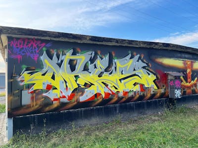 Colorful and Grey Stylewriting by ORES24. This Graffiti is located in Wernigerode, Germany and was created in 2021. This Graffiti can be described as Stylewriting and Characters.