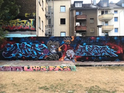 Colorful Stylewriting by Gaps and Juicey. This Graffiti is located in Köln, Germany and was created in 2022. This Graffiti can be described as Stylewriting, Characters and Wall of Fame.