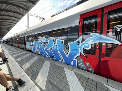 Light Blue and White and Grey Stylewriting by bros and milov. This Graffiti is located in Leipzig, Germany and was created in 2021. This Graffiti can be described as Stylewriting and Trains.