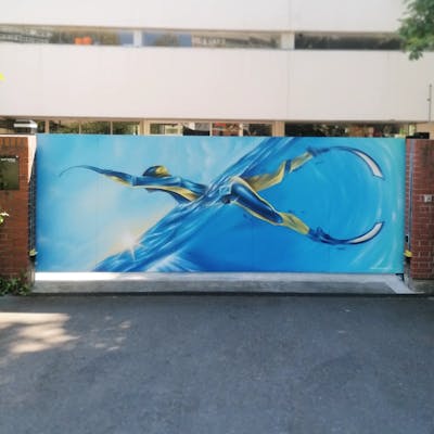 Light Blue and Yellow Characters by Atelier wandART. This Graffiti is located in Basel, Switzerland and was created in 2022. This Graffiti can be described as Characters and Commission.