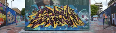Yellow and Violet and Light Blue Stylewriting by Chips and DavePlant. This Graffiti is located in London, United Kingdom and was created in 2021. This Graffiti can be described as Stylewriting, Characters, Murals and Wall of Fame.
