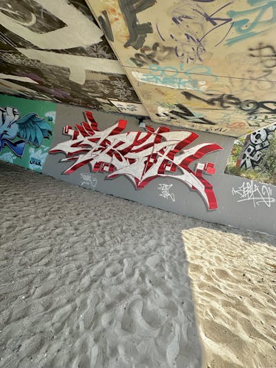 Red and Chrome Stylewriting by Abik. This Graffiti is located in Laboe, Germany and was created in 2023. This Graffiti can be described as Stylewriting and Wall of Fame.