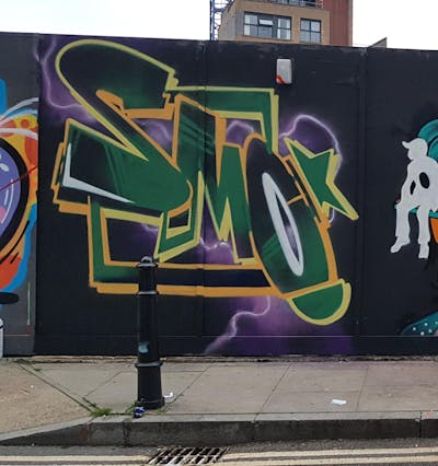 Colorful and Green Stylewriting by smo__crew and Core246. This Graffiti is located in London, United Kingdom and was created in 2023. This Graffiti can be described as Stylewriting and Wall of Fame.