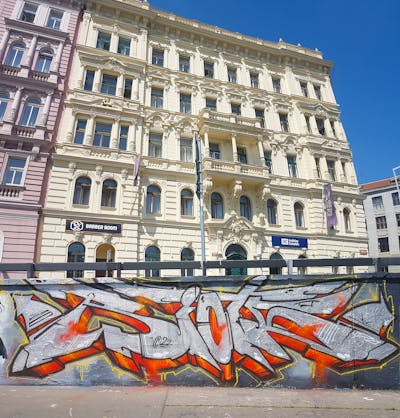 Chrome and Colorful Stylewriting by Riots. This Graffiti is located in Prague, Czech Republic and was created in 2022. This Graffiti can be described as Stylewriting and Wall of Fame.