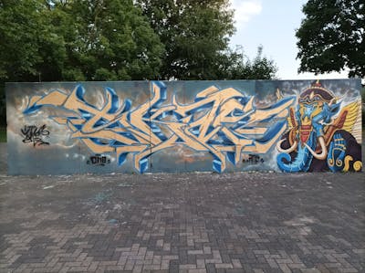 Gold and Blue Stylewriting by Skaf, ATC and ONB. This Graffiti is located in Bitterfeld, Germany and was created in 2022. This Graffiti can be described as Stylewriting, Characters and Wall of Fame.
