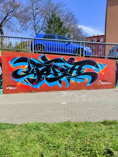Light Blue and Black and Orange Stylewriting by Utopia. This Graffiti is located in Liberec, Czech Republic and was created in 2023. This Graffiti can be described as Stylewriting and Wall of Fame.