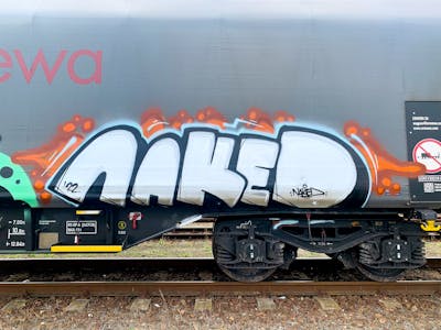 Chrome and Orange and Black Stylewriting by Naked. This Graffiti is located in Budapest, Hungary and was created in 2022. This Graffiti can be described as Stylewriting, Freights and Trains.