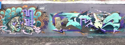 Cyan and Violet Stylewriting by Nekos and Eight. This Graffiti is located in Italy and was created in 2022. This Graffiti can be described as Stylewriting, Characters and Wall of Fame.