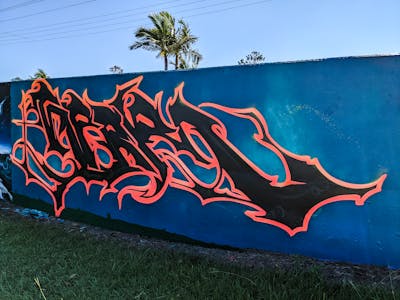 Orange and Black Stylewriting by Cc_pinturas. This Graffiti is located in Murwillumbah, Australia and was created in 2021. This Graffiti can be described as Stylewriting and Wall of Fame.