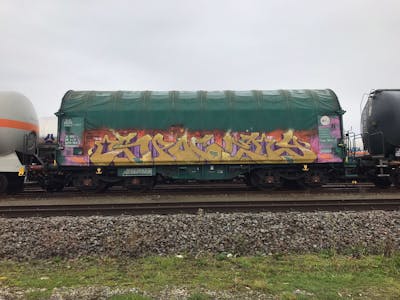 Beige and Colorful Trains by Spocey, TML, cab, WH and IFC. This Graffiti is located in Belgium and was created in 2021. This Graffiti can be described as Trains and Stylewriting.
