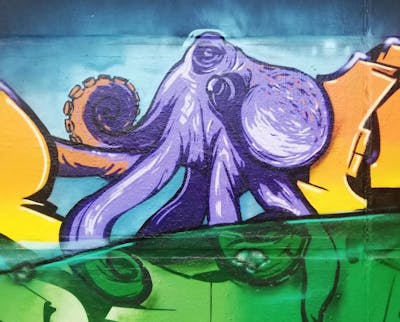 Violet and Green and Orange Characters by LGQ. This Graffiti is located in Leipzig, Germany and was created in 2022. This Graffiti can be described as Characters and Wall of Fame.