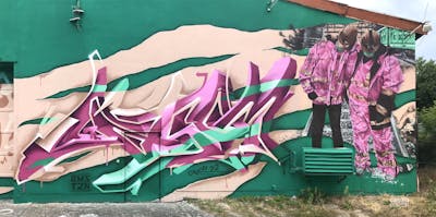 Cyan and Coralle Stylewriting by casom, 7hells and home 87. This Graffiti is located in Radebeul, Germany and was created in 2022. This Graffiti can be described as Stylewriting, Characters, 3D, Murals and Wall of Fame.