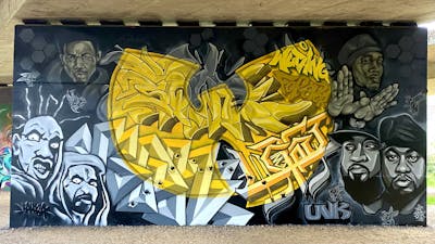 Grey and Yellow Murals by Last, Kah124, SQWR and UVK Crew. This Graffiti is located in United Kingdom and was created in 2024. This Graffiti can be described as Murals, Streetart, Characters and Stylewriting.