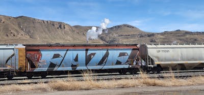Light Blue and Black Trains by Faze. This Graffiti is located in United States and was created in 2023. This Graffiti can be described as Trains, Freights, Wholecars and Stylewriting.