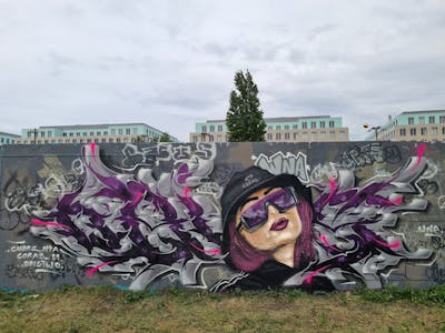Grey and Violet Stylewriting by CUORE and Obistwo. This Graffiti is located in Berlin, Germany and was created in 2022. This Graffiti can be described as Stylewriting, Characters and Wall of Fame.