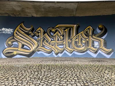 Beige and Black Stylewriting by TROZ ONE. This Graffiti is located in Innsbruck, Austria and was created in 2024.