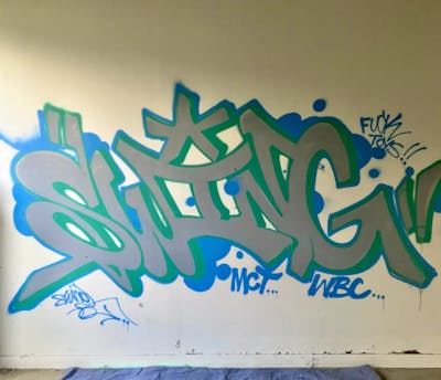 Grey and Light Blue and Green Stylewriting by MCT, WBC and Swing. This Graffiti is located in Lyon, France and was created in 2023.