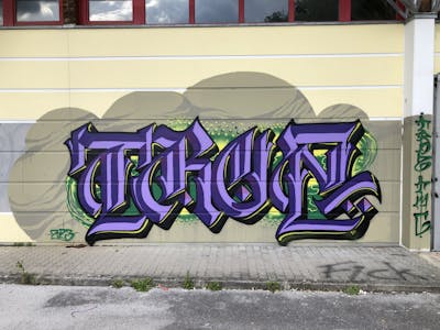 Violet and Beige and Green Stylewriting by TROZ ONE. This Graffiti is located in Landeck, Austria and was created in 2023.