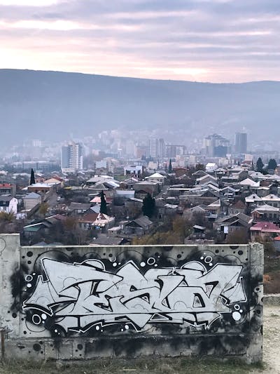 Chrome and Black Stylewriting by Tesla. This Graffiti is located in Tbilisi, Georgia and was created in 2021. This Graffiti can be described as Stylewriting, Street Bombing and Atmosphere.