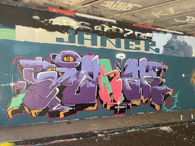 Violet and Colorful Stylewriting by Janek. This Graffiti is located in Rotterdam, Netherlands and was created in 2022. This Graffiti can be described as Stylewriting and Wall of Fame.