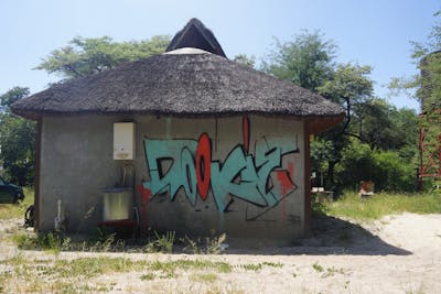 Cyan and Red Stylewriting by Dj Dookie and WKS. This Graffiti is located in Namibia and was created in 2022. This Graffiti can be described as Stylewriting and Street Bombing.