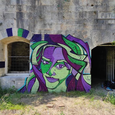 Violet and Light Green Characters by SMOKI. This Graffiti is located in Pula, Croatia and was created in 2023. This Graffiti can be described as Characters, Streetart and Abandoned.