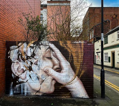 Gold and Beige Characters by liambononi. This Graffiti is located in Manchester, United Kingdom and was created in 2022. This Graffiti can be described as Characters and Murals.